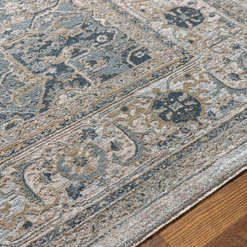 Close up of the Whangamata Thick Luxe Boutique Rug showing its traditional pattern and texture in shades of gray, blue, and taupe. Texture
