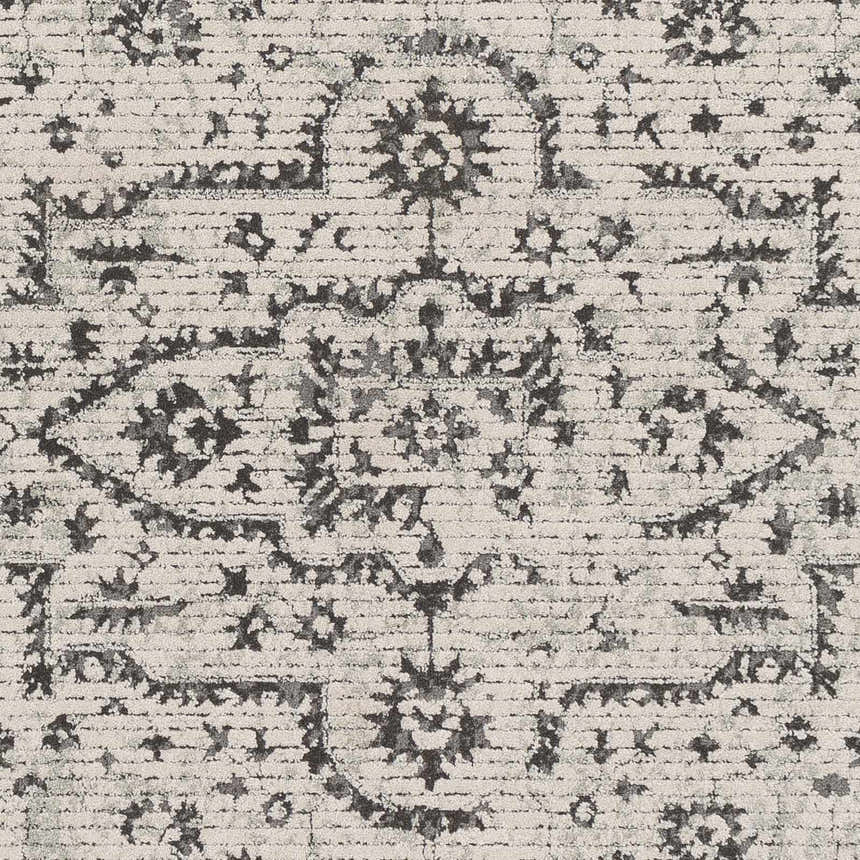 Close-up of the Willowbrook Area Rug showing a charcoal and gray vintage-style pattern on a light beige background. Texture