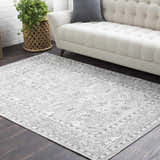 Living room scene with a light sofa and gray Winstonville Clearance Rug on dark wood floor. Roomscene-Rectangle
