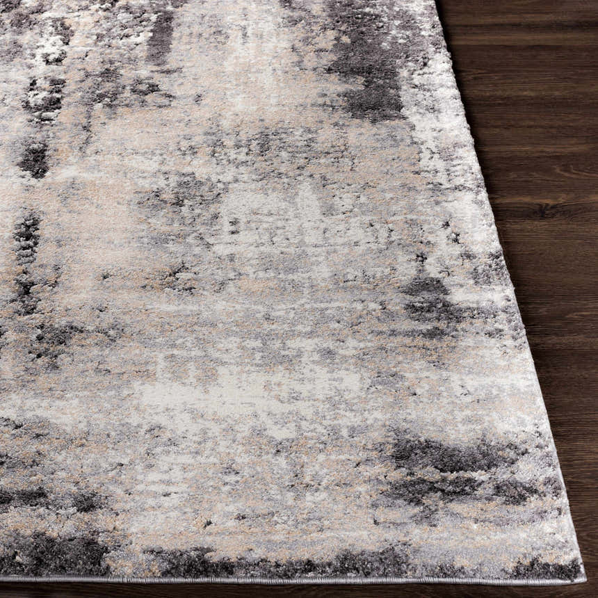 Close-up of the Witchford Abstract Charcoal Thick Rug, showcasing its black, gray, ivory, and tan pattern and texture. Front