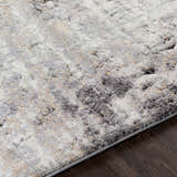 Close-up of the Witchford Abstract Charcoal Thick Rug. Soft texture with charcoal, gray, ivory, and tan abstract pattern. Texture