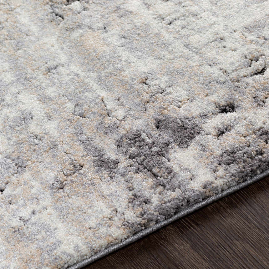Close-up of the Witchford Abstract Charcoal Thick Rug. Soft texture with charcoal, gray, ivory, and tan abstract pattern. Texture