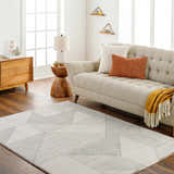 Living room scene with a beige sofa and the geometric Wald Area Rug in beige and brown. Roomscene-Rectangle