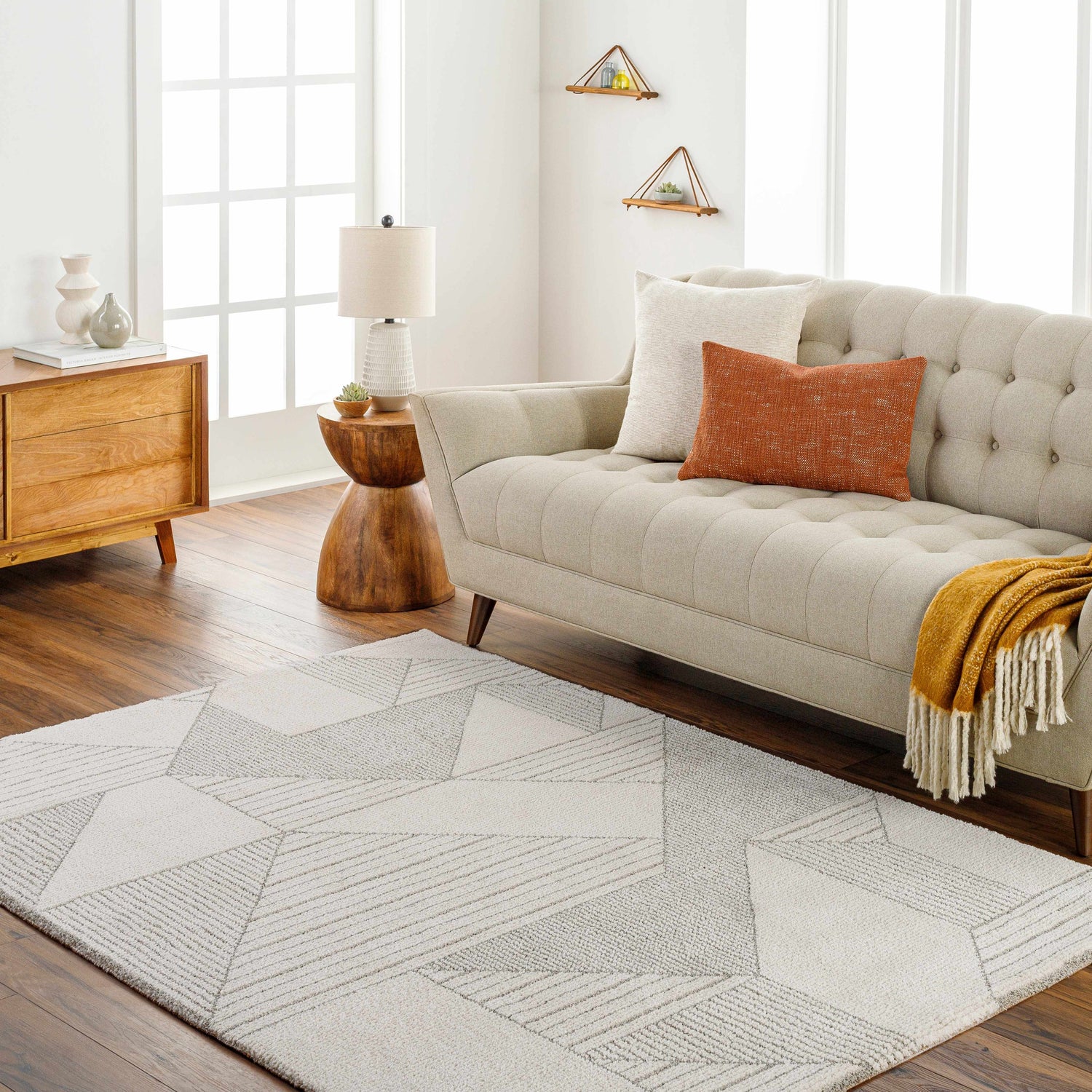 Living room scene with a beige sofa and the geometric Wald Area Rug in beige and brown. Roomscene-Rectangle