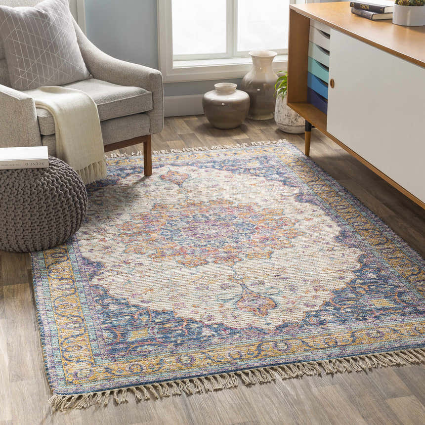 Living room scene with Wallburg colorful tassel rug, gray chair, and modern cabinet. Roomscene-Rectangle