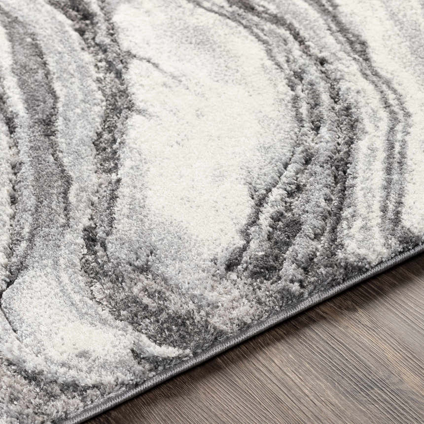 Close-up of the Walloon Gray Marble Thick Rug, showing its charcoal, gray, and ivory swirling marble pattern and textured weave. Texture