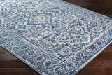 Close-up of the blue and light gray Wellsblue Traditional Rug featuring a vintage, oriental-inspired pattern. Corner