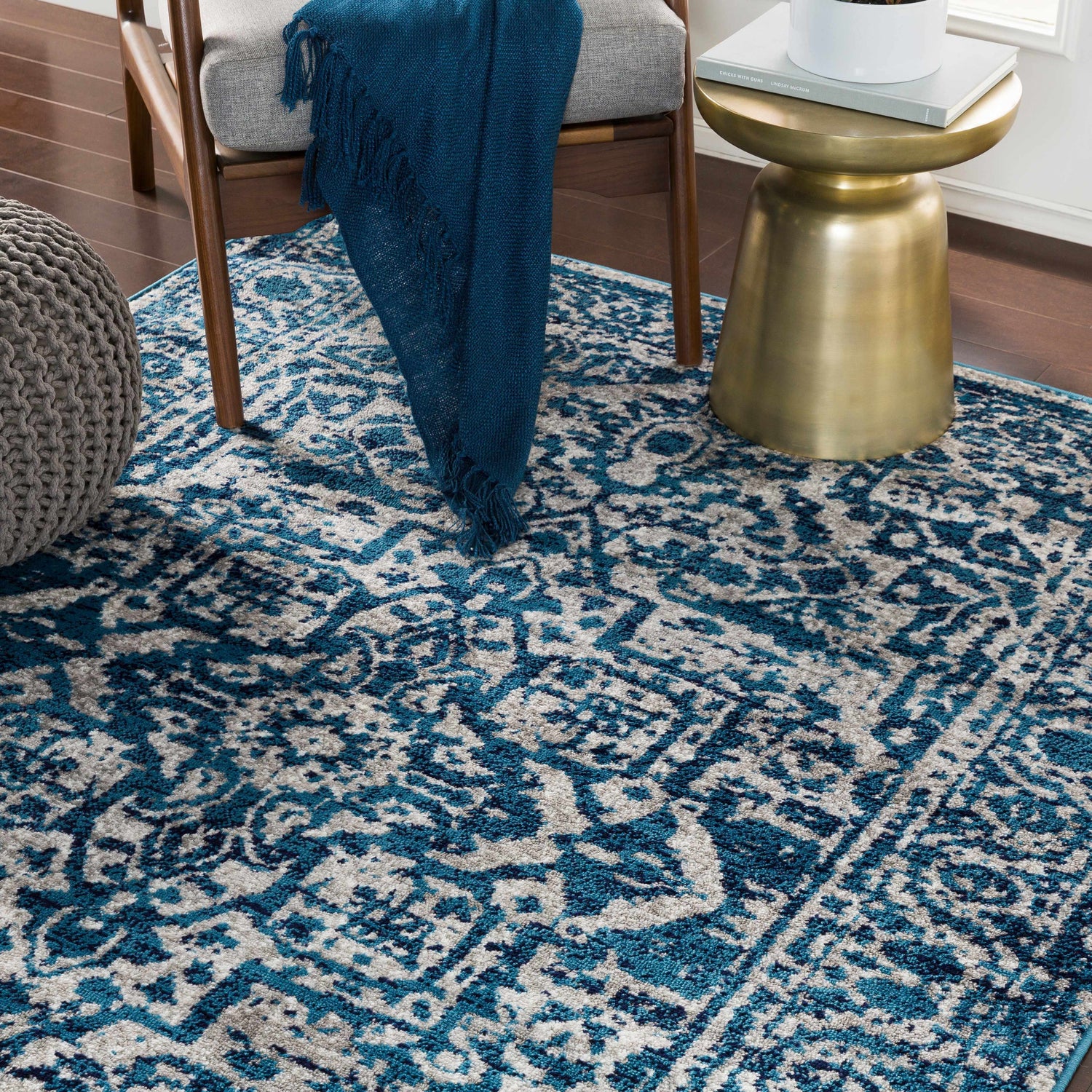 Living room scene with blue and gray Wellsblue Traditional Rug, chair, and gold accent table. Roomscene-Rectangle