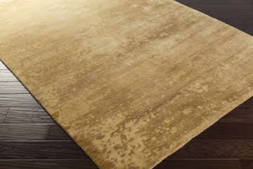 Close up of the Owensboro Area Rug showing beige, mustard, and wheat tones with a subtle contemporary pattern. Corner