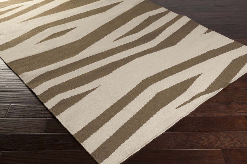 Close-up of the Wolford Area Carpet. Hand-woven wool rug with a contemporary brown and light beige zebra stripe pattern. Corner