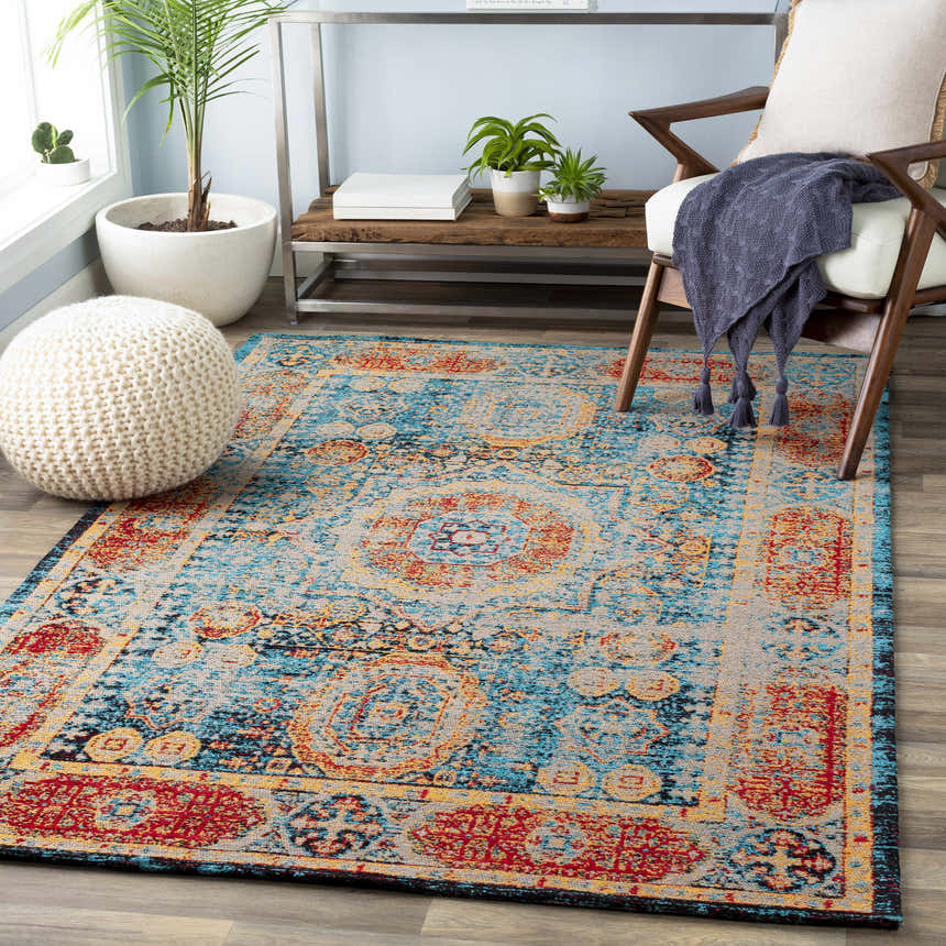 Living room scene with Wrangell Blue/Red Damask Carpet, wood chair, and knitted pouf. Bohemian, vintage style. Roomscene-Rectangle