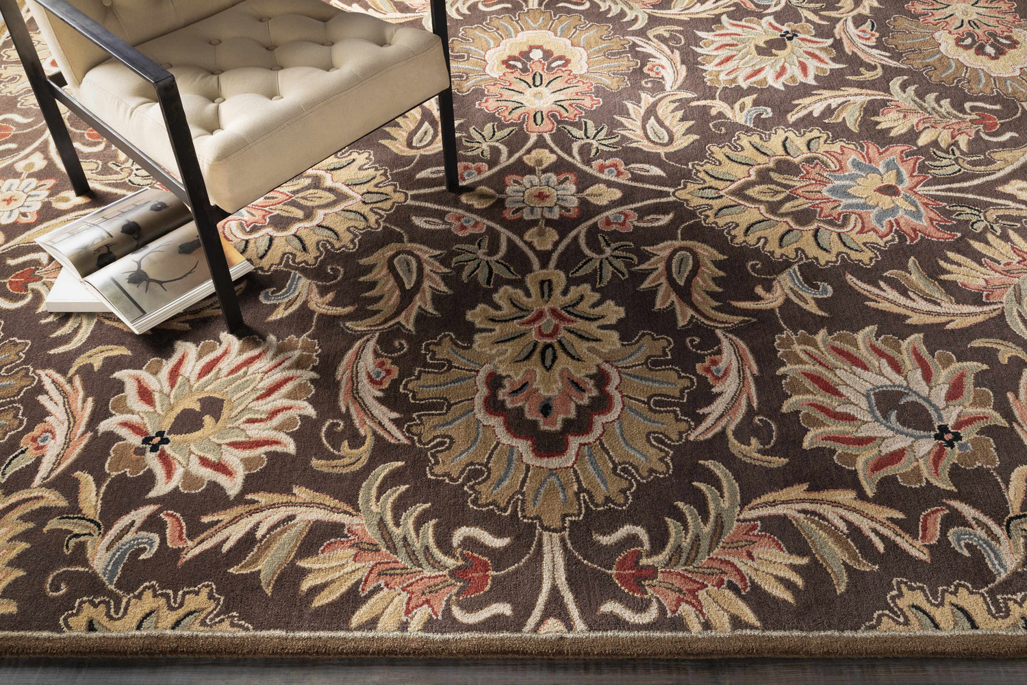 Close-up of the Chesterton 1028 brown wool rug featuring a traditional floral pattern in brown, beige, red, and gray tones. Front