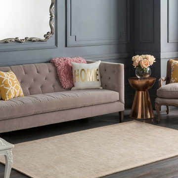 Living room scene with a taupe Westbend Area Rug, tufted sofa, and gray walls. Roomscene-Rectangle