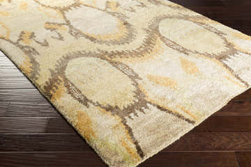 Close-up of Westhoff Jute Area Rug showing beige, tan, mustard, and olive tones with a Southwestern-inspired pattern. Corner