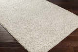 Close-up of the hand woven Wurtland Carpet. Ivory and medium brown wool rug with a farmhouse style texture. Corner