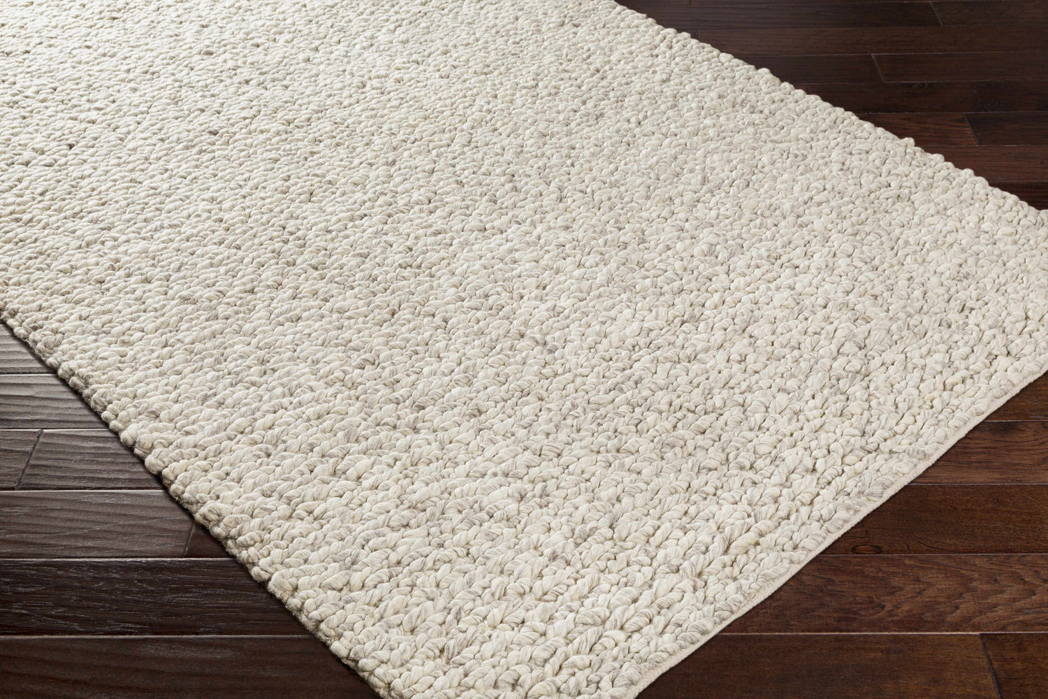 Close-up of the hand woven Wurtland Carpet. Ivory and medium brown wool rug with a farmhouse style texture. Corner