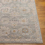 Close-up of the Wurtulla Thick Luxe Statement Rug. Features a traditional floral pattern in dusty sage, beige, and brown tones. Front