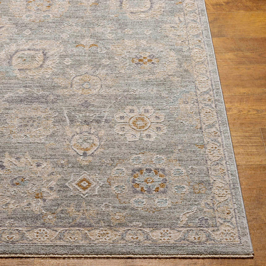Close-up of the Wurtulla Thick Luxe Statement Rug. Features a traditional floral pattern in dusty sage, beige, and brown tones. Front