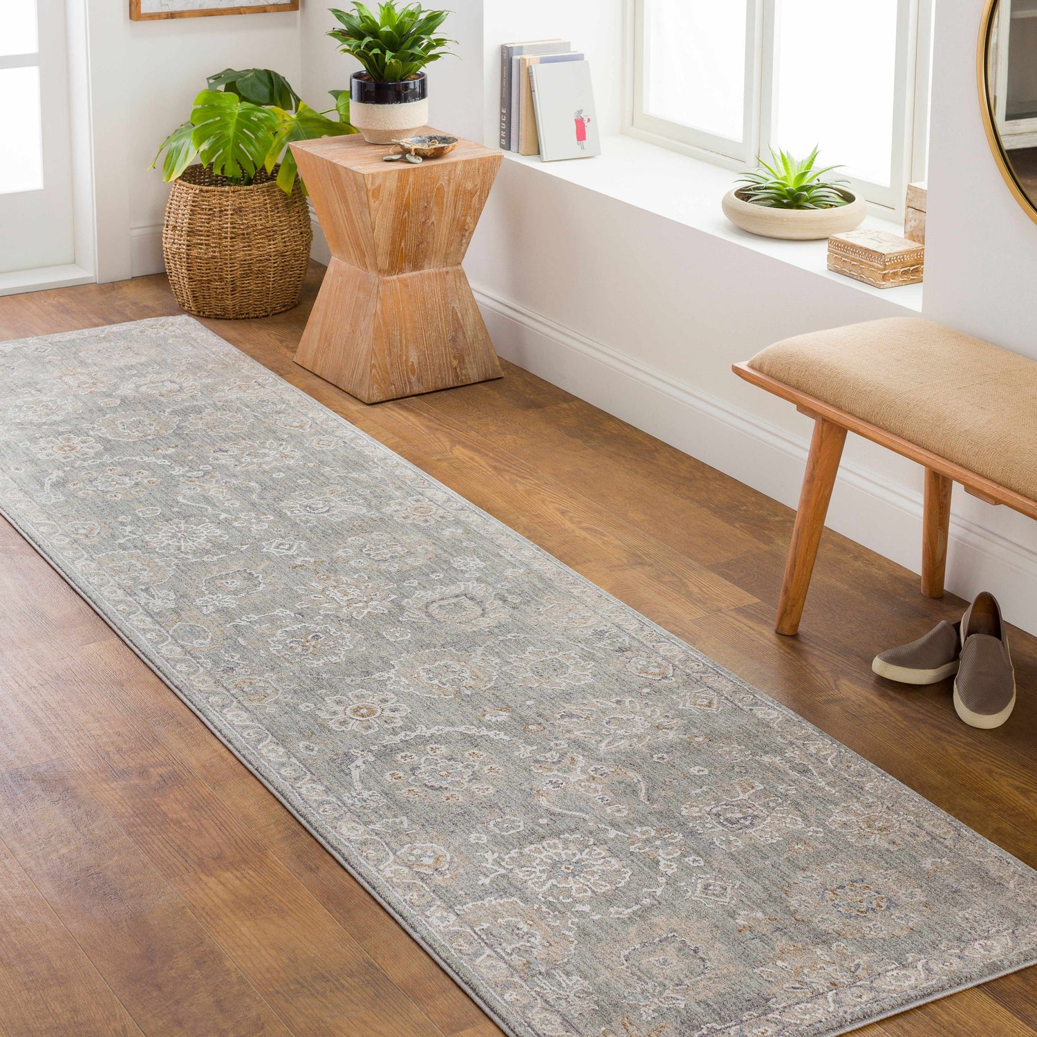Entryway with a gray Wurtulla Thick Luxe Statement Rug, wooden bench, plants, and light wood floors. Roomscene-Runner
