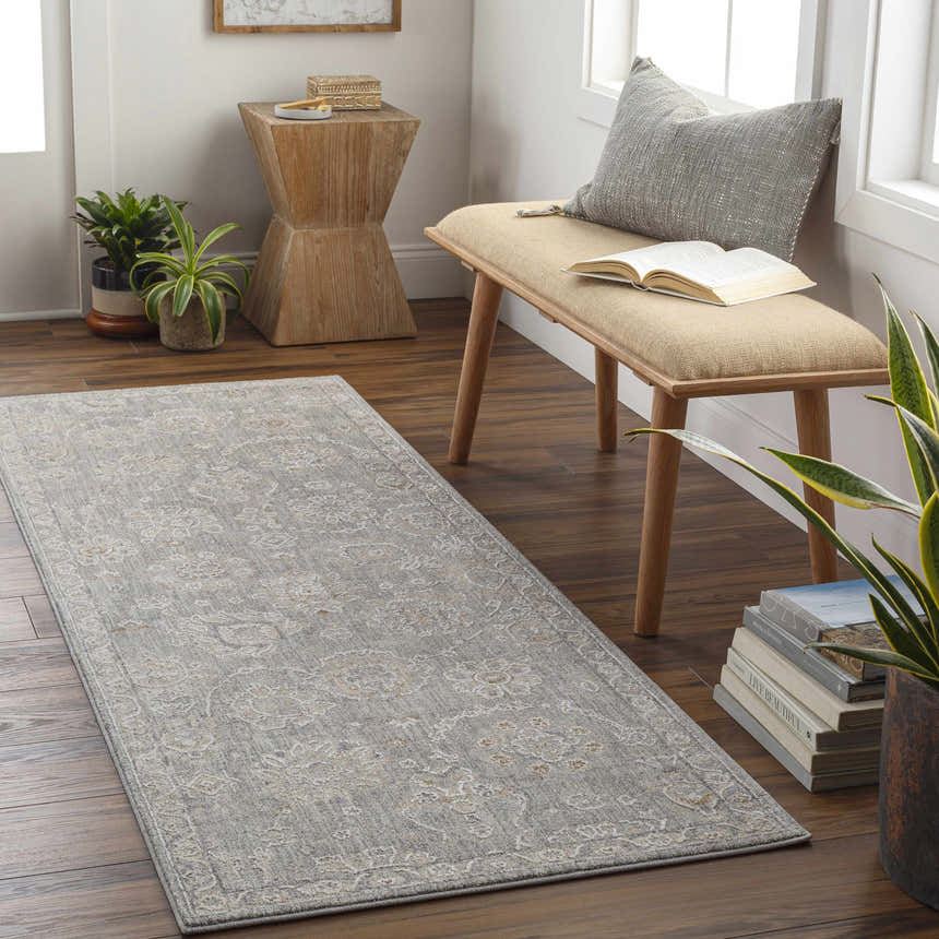 Entryway scene with a gray Wurtulla Thick Luxe Statement Rug, wooden bench, plants, and hardwood floors. Roomscene-Runner