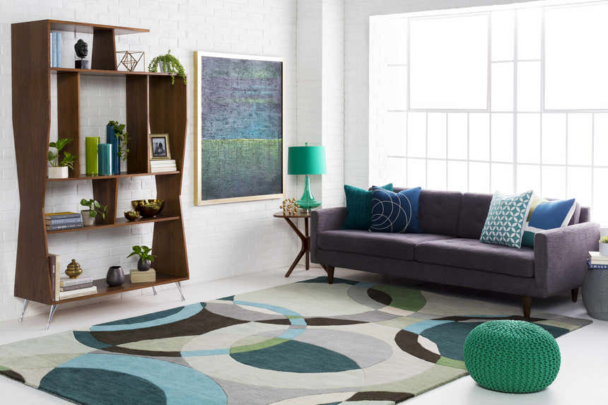 Living room scene with a gray sofa and Wyocena Wool Rug in aqua, gray, green, and brown circle pattern. Mid-century modern style. Roomscene-Rectangle