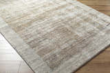 Close up of the Xandy Thick Luxe Rug, a contemporary beige, tan, and light gray rug with a subtle pattern. Corner