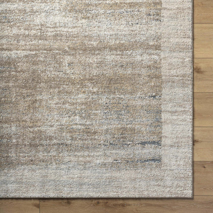 Close-up of the Xandy Thick Luxe Rug. Beige, light gray, and tan hues create a contemporary, textured pattern. Corner