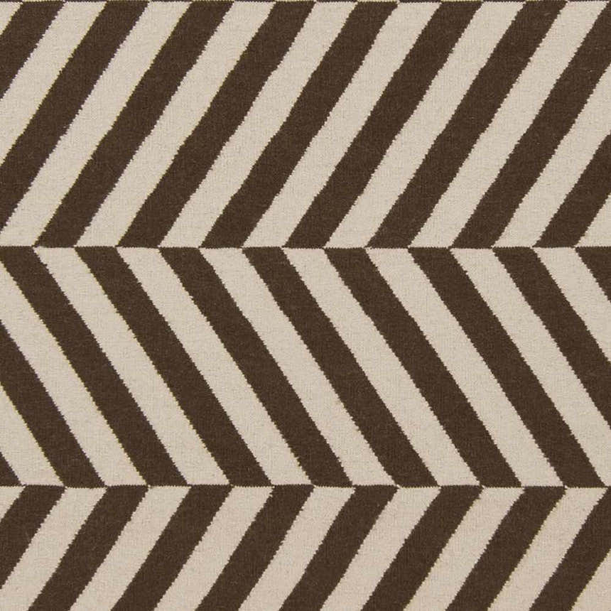 Close-up of the Yards Area Rug showing a brown and cream chevron stripe pattern. Hand woven wool texture. Swatch