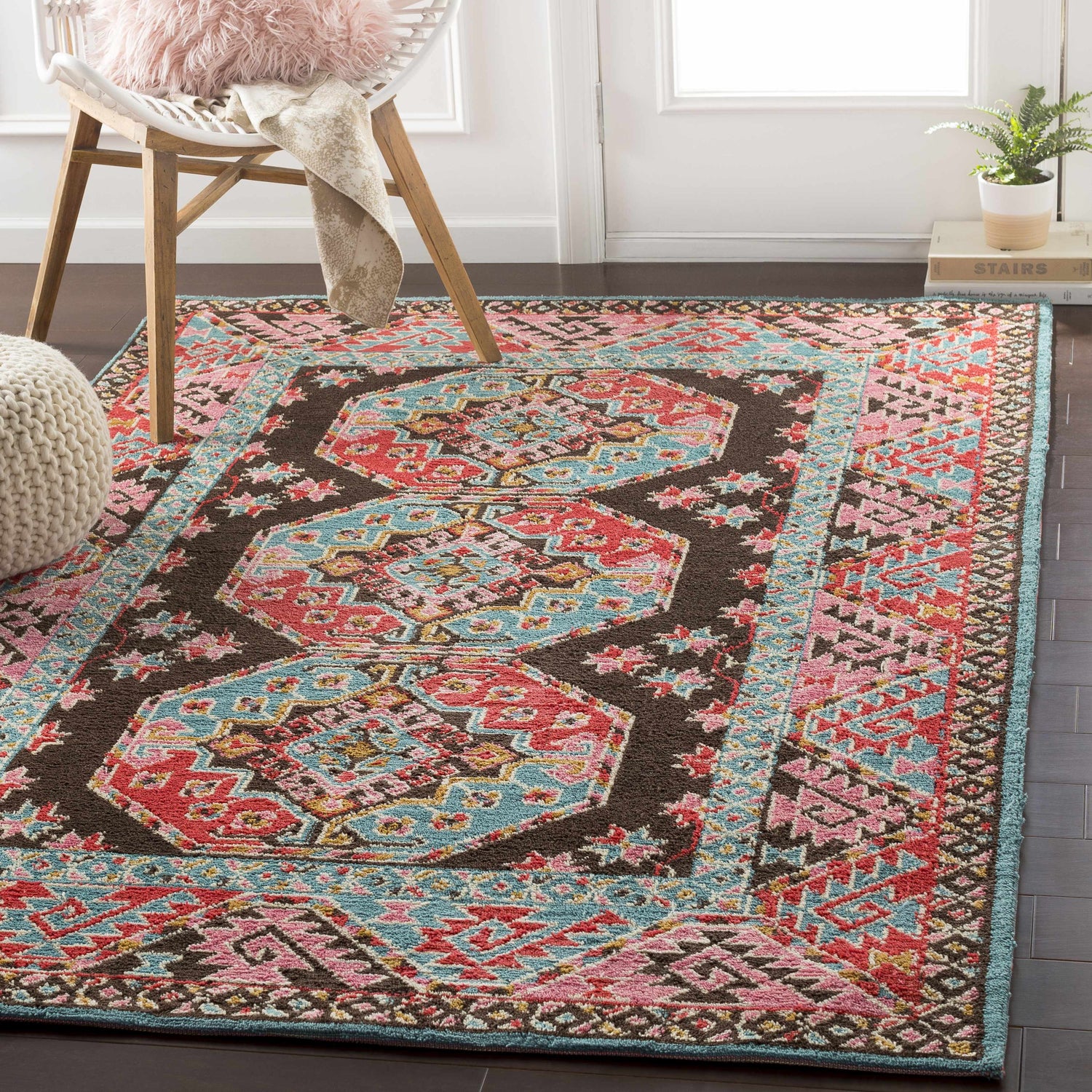 Entryway with brown floors and Yettem Clearance Rug. Aqua, pink, and red traditional rug with chair and pouf. Roomscene-Rectangle