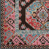 Close-up of the Yettem Clearance Rug showing its traditional design, aqua, pink, red, and brown colors, and machine-woven texture. Swatch