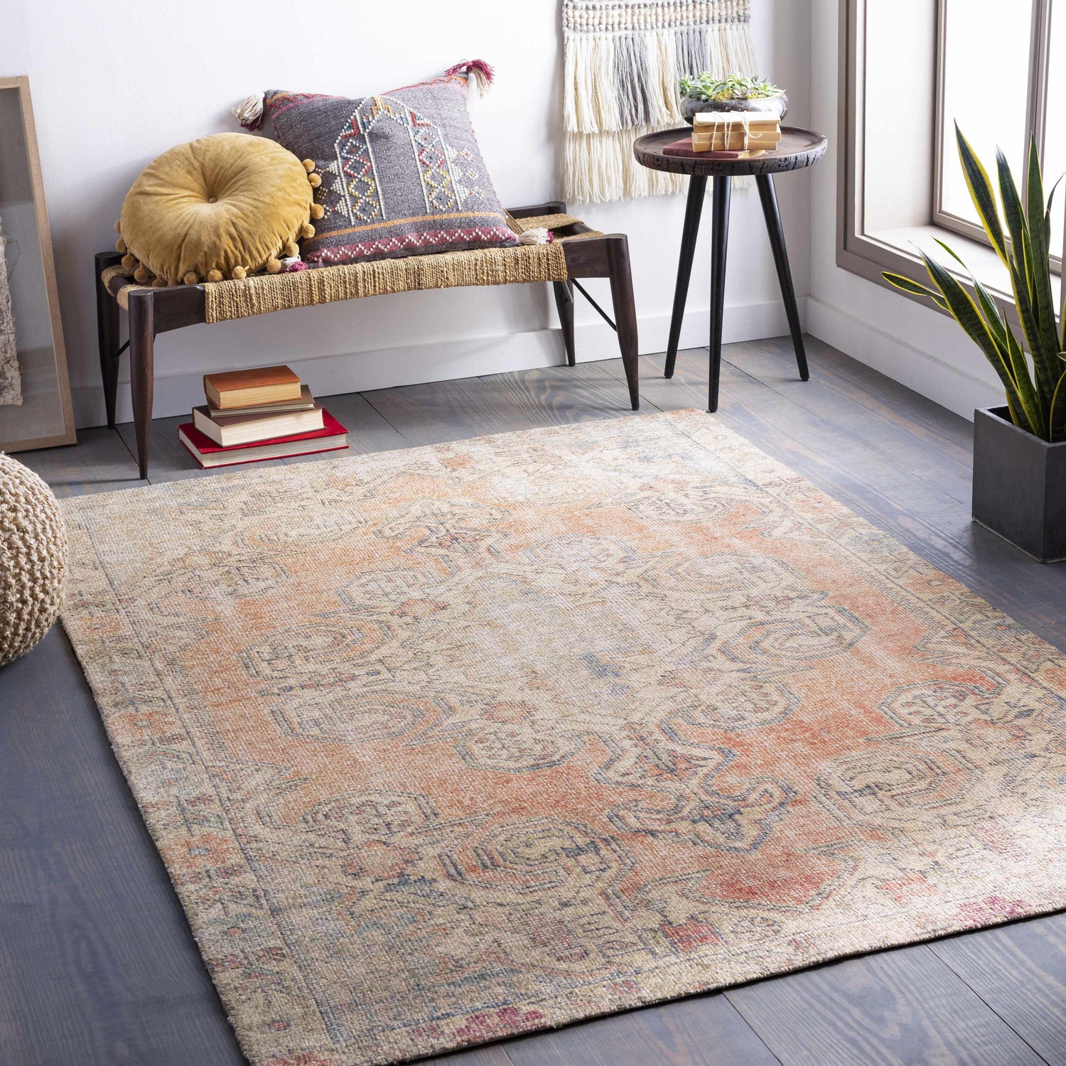 Bohemian room scene with Yetminster Traditional Distressed Peach Rug, bench, pillows, and wood floors. Roomscene-Rectangle