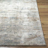 Close-up of the beige, gray, and tan Yoshe Thick Luxe Rug showing its contemporary design and soft, textured pile. Front