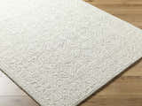 Close-up of the hand-tufted Yadid Sage Wool Area Rug, showing its subtle traditional pattern and soft, textured wool pile. Corner