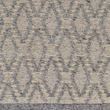 Close-up of the Yank Area Rug. Hand-woven rug with a geometric diamond pattern in dark gray and light gray. Farmhouse style. Swatch
