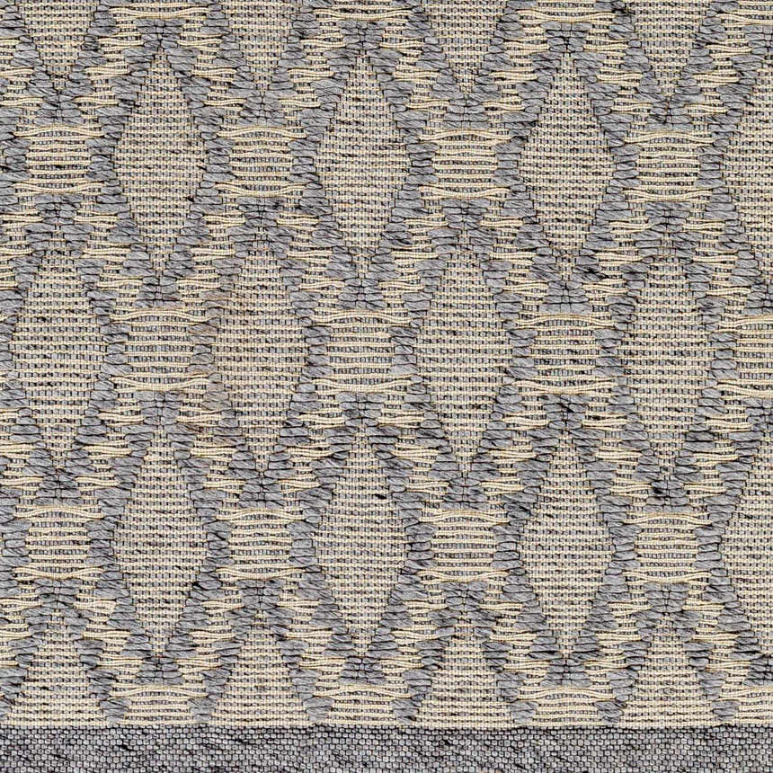 Close-up of the Yank Area Rug. Hand-woven rug with a geometric diamond pattern in dark gray and light gray. Farmhouse style. Swatch