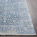 Close-up of the Yorkana Distressed Blue Rug. Features a vintage-inspired oriental pattern in blue, beige, and gray tones. Front