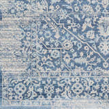 Close-up of the Yorkana Distressed Blue Rug, showcasing its traditional floral pattern and distressed texture in blue and beige. Swatch