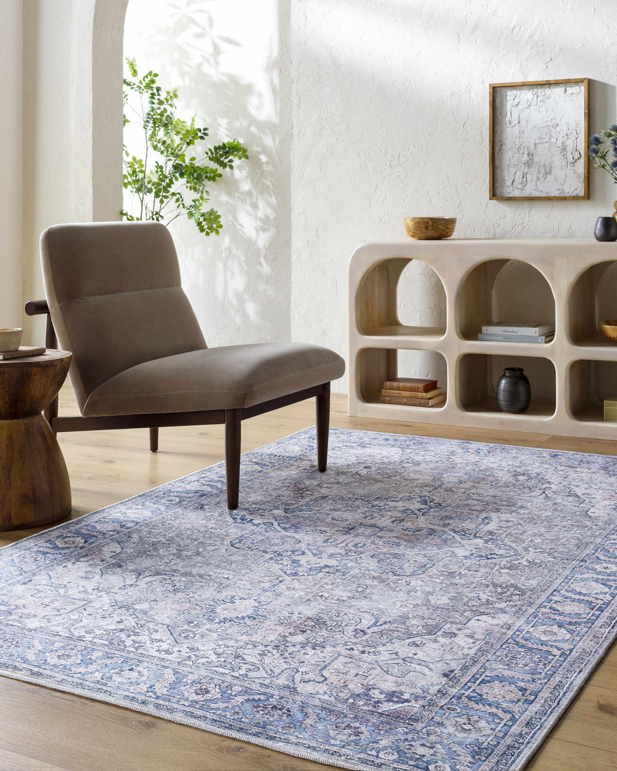 Living room scene with a blue Yoshi Washable Area Rug, gray chair, and white console table. Farmhouse style. Roomscene-Rectangle
