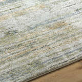 Close-up of the Yancy Thick Luxe Rug. Beige, gray, light gray, olive, and tan colors with a contemporary style. Texture