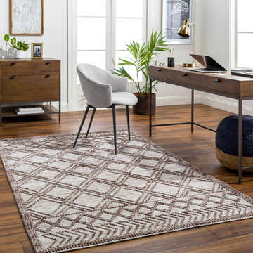 Home office scene with a gray chair and the brown and gray geometric-patterned Yuta Area Rug on hardwood floors. Roomscene-Rectangle
