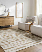 Living room scene with camel and pearl Zofia Area Rug, light wood floors, modern chairs, and wood cabinet. Roomscene-Rectangle
