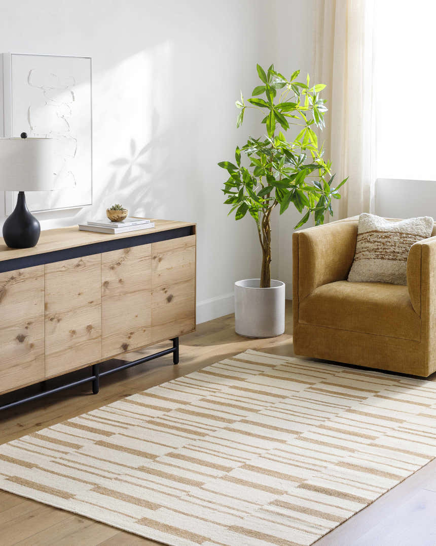 Living room scene with a camel armchair and a Zofia area rug in camel and pearl with a contemporary stripe design. Roomscene-Rectangle