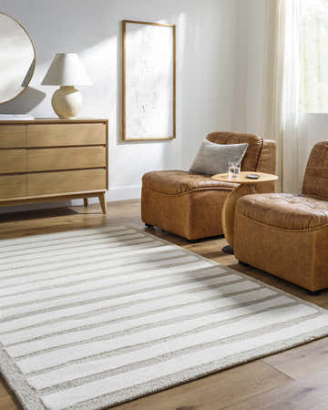 Living room scene with leather chairs and a Zerah Area Rug in ash and silver gray. Roomscene-Rectangle
