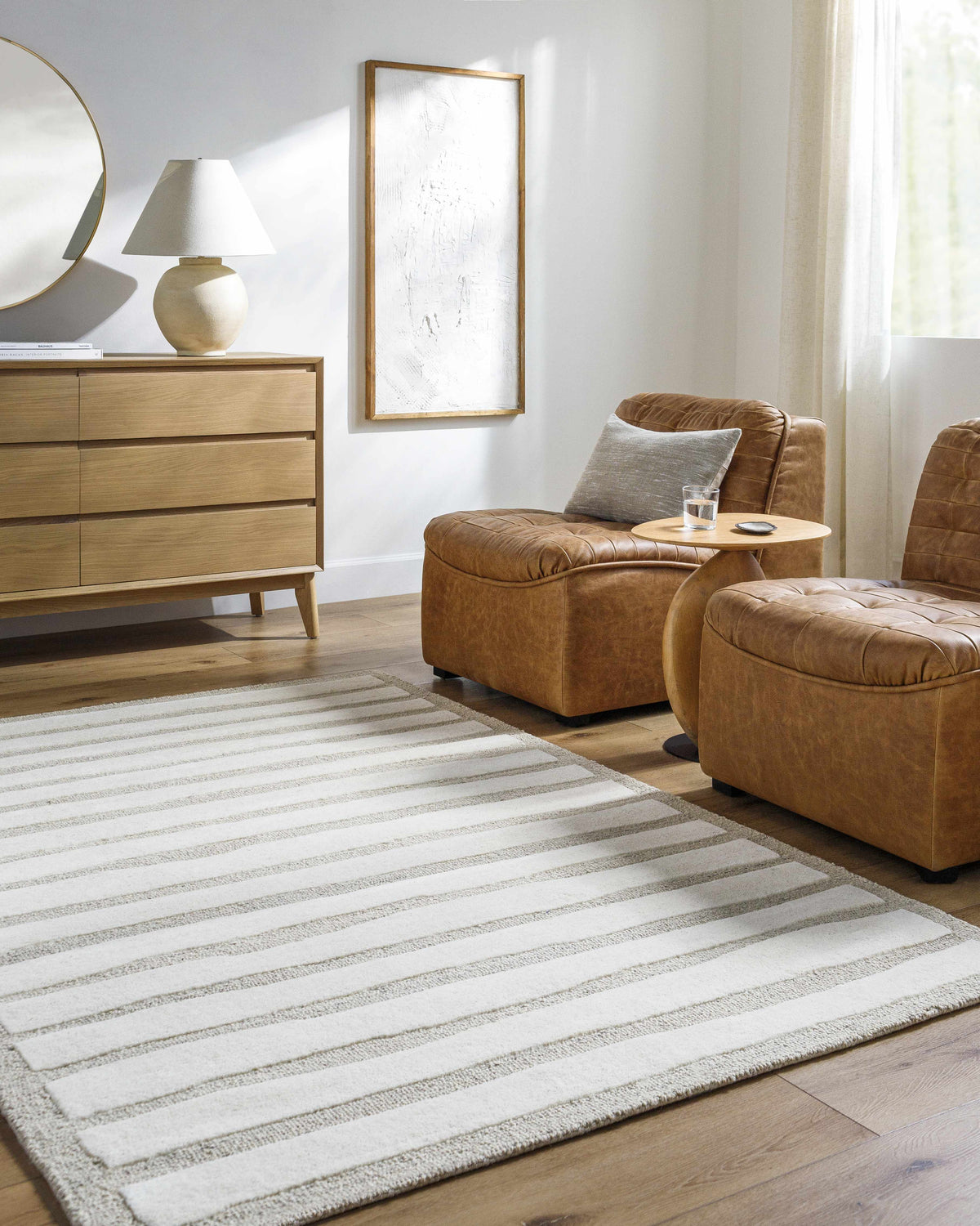Living room scene with leather chairs and a Zerah Area Rug in ash and silver gray. Roomscene-Rectangle