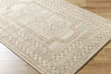 Close-up of the hand-tufted Zlata Area Rug. Farmhouse style rug in pearl and tan with geometric pattern. 100% Wool. Corner