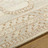 Close-up of the Zlata Area Rug. Hand-tufted wool rug in pearl and tan with a farmhouse-style geometric pattern. Texture