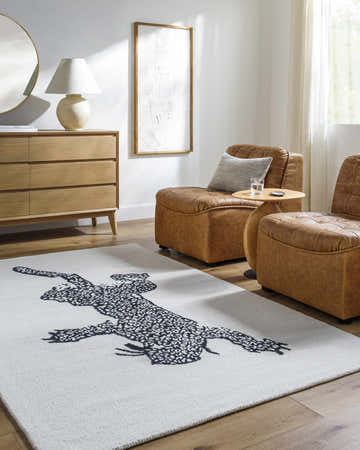 Living room scene with leather chairs and off white Zosia Area Rug with black animal print. Roomscene-Rectangle